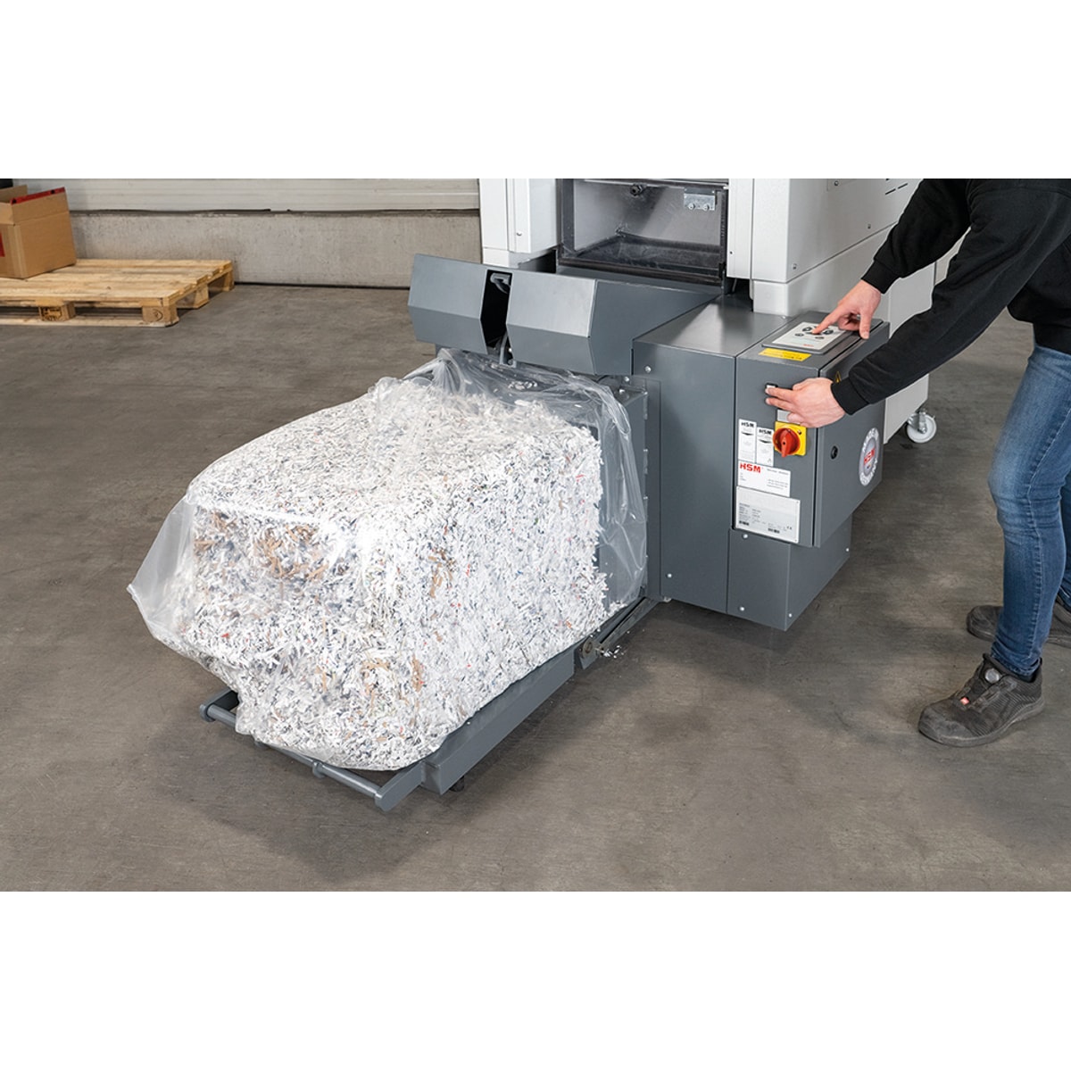 Une balle de papier compressé sort de la presse de la combinaison destructeur-presse HSM Powerline SP 5080